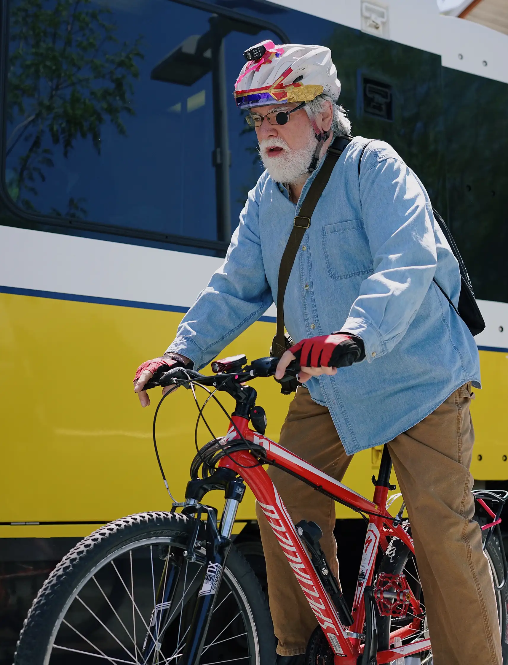 Elderly man riding bike near LRV